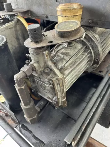 Original worn pump on a Kew 1502V hot pressure washer before full pump recondition and restoration.
